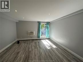 Chatham apartment for rent - A room with wooden flooring and a window with a view of trees outside.