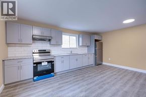 Windsor apartment for rent - A kitchen with a stove top oven and a refrigerator.