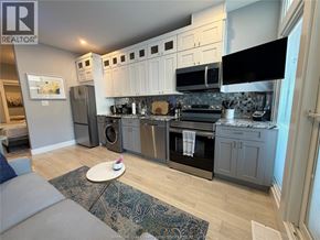 Windsor condo for rent - A kitchen with a grey and white color scheme.