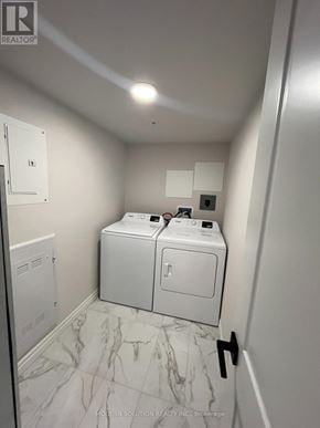Kitchener condo for rent - A bathroom with a toilet, sink, and a marble floor.