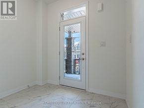 Haldimand townhouse for rent - A white door with a glass window is in a room with white walls.