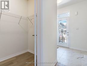Haldimand townhouse for rent - A room with a white door and a view of a house through the door.