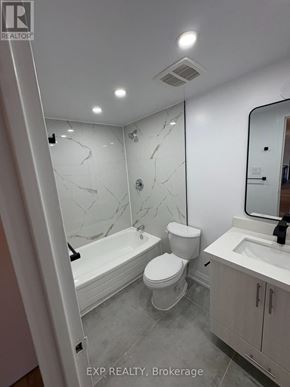 Niagara Falls (Downtown) apartment for rent - A white bathroom with marble tiles and a bathtub.