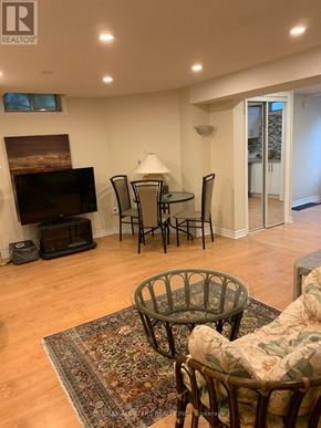 Markham (Unionville) apartment for rent - A living room with a fireplace, chairs, and a rug.