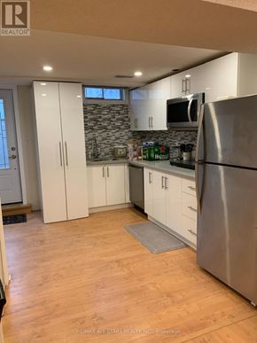 Markham (Unionville) apartment for rent - A kitchen with a refrigerator, cabinets, and a countertop.