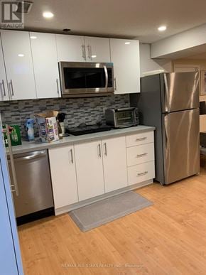 Markham (Unionville) apartment for rent - A kitchen with white cabinets and a stainless steel refrigerator.