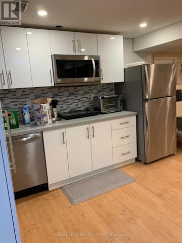Markham (Unionville) apartment for rent - A kitchen with white cabinets and a stainless steel refrigerator.