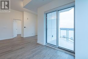 Barrie (Little Lake) condo for rent - A room with a sliding glass door leading to a balcony.