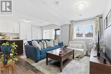 Brampton (Northwest Brampton) apartment for rent - A living room with a blue couch and a wooden coffee table.