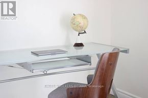 Ottawa townhouse for rent - A globe on a desk with a laptop and a wooden chair.