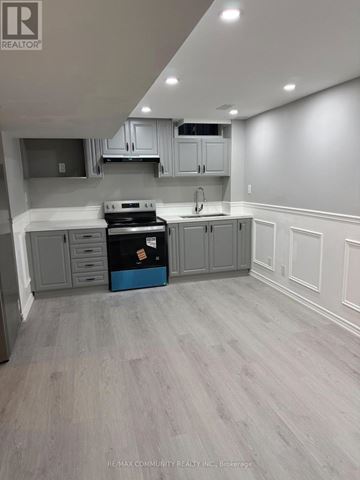 Whitchurch-Stouffville (Stouffville) apartment for rent - A kitchen with grey cabinets and a blue box on the counter.