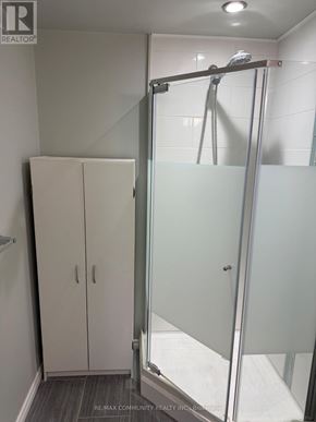 Whitchurch-Stouffville (Stouffville) apartment for rent - A bathroom with a glass shower door and a glass-enclosed shower stall.