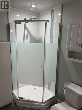 Whitchurch-Stouffville (Stouffville) apartment for rent - A glass shower stall with a white toilet next to it.