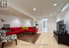 Vaughan (Lakeview Estates) apartment for rent - A living room with a red couch and a television.