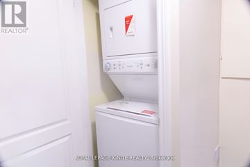 Brampton (Fletcher's Meadow) apartment for rent - A white dishwasher and refrigerator in a small kitchen.
