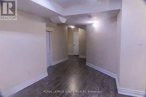 Brampton (Fletcher's Meadow) apartment for rent - A room with wooden flooring and white walls, with a door on the left and a window on the right.