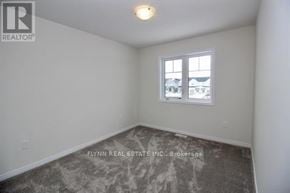 Haldimand townhouse for rent - A room with a window and a view of other buildings outside.