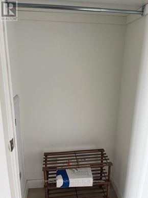 Kitchener condo for rent - A small room with a bench and a sign that says "REALTOR".