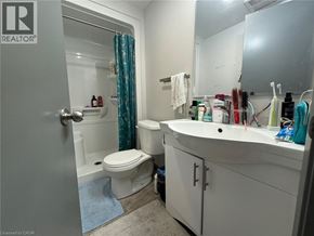 Waterloo condo for rent - A bathroom with a toilet, sink, and shower.