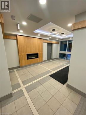 Waterloo condo for rent - A hallway with a fireplace and a black and white tiled floor.