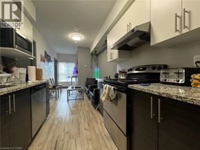 Waterloo condo for rent - A kitchen with a black stove top oven and a black refrigerator.