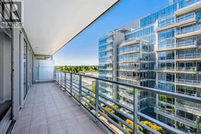 Richmond apartment for rent - A balcony with a glass railing overlooks a modern building.