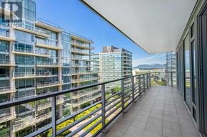 Richmond apartment for rent - A balcony with a metal railing overlooks a cityscape.