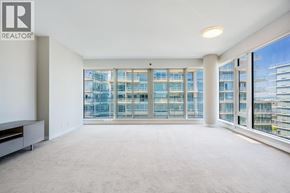 Richmond apartment for rent - A spacious, well-lit room with large windows overlooking a cityscape.
