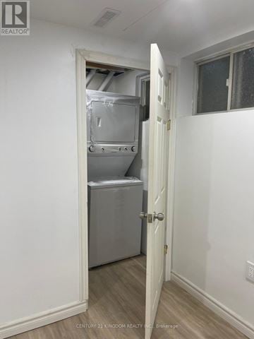 Pickering (Liverpool) apartment for rent - A white door is open to a small kitchen with a refrigerator and a cabinet.