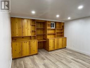 Pickering (Liverpool) apartment for rent - A room with wooden shelves and cabinets.