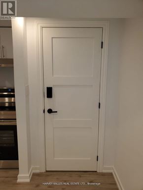 Newmarket (Central Newmarket) apartment for rent - A white door with a black handle and lock in a room.