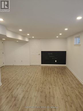 Newmarket (Central Newmarket) apartment for rent - A room with wooden flooring and a blackboard on the wall.