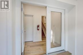 Toronto (Annex) apartment for rent - A white door with a glass window is open to a hallway.