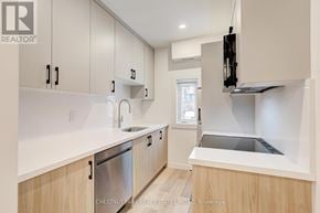 Toronto (Annex) apartment for rent - A modern kitchen with wooden cabinets and stainless steel appliances.