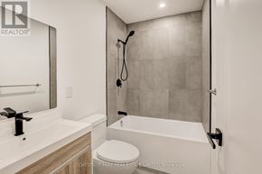 Toronto (Annex) apartment for rent - A modern bathroom with a white toilet and a walk-in shower.