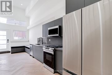 Toronto (O'connor-Parkview) duplex for rent - A modern kitchen with a stove top oven and a microwave above it.