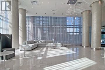 Richmond Hill (Langstaff) condo for rent - A modern living room with a large white sofa and a television.