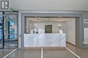 Richmond Hill (Langstaff) condo for rent - A reception area with a marble counter and a glass door.