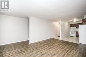 Toronto (Kingsway South) multi-family for rent - A large, empty room with wood flooring and white walls.