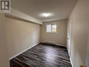 Peterborough (Town Ward 3) apartment for rent - A room with a wooden floor and a window.