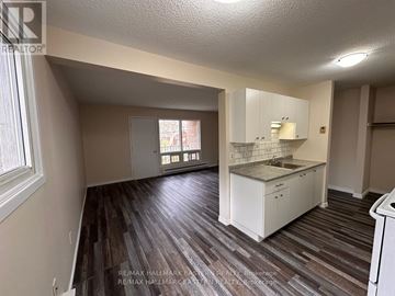 Peterborough (Town Ward 3) apartment for rent - A kitchen area with white cabinets and a wooden floor.