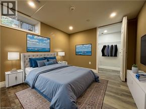 Kitchener apartment for rent - A bedroom with a large bed and a painting on the wall.