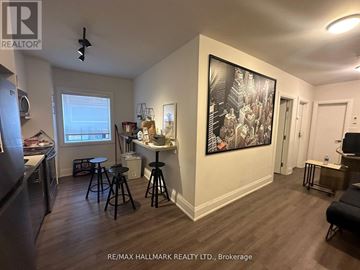 Toronto (Wychwood) multi-family for rent - A living room with a bar stool and a painting on the wall.