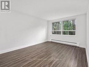 Kitchener condo for rent - A room with a window and a wooden floor.