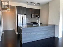 Mississauga (City Centre) condo for rent - A kitchen with a countertop and a refrigerator.