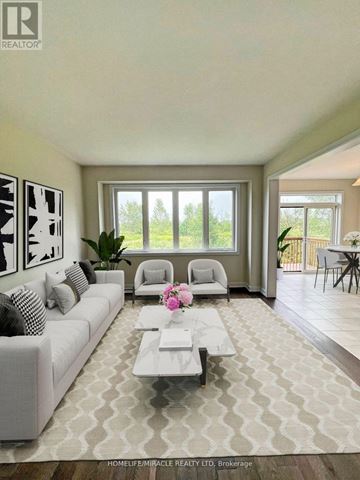 Welland (Dain City) apartment for rent - A well-lit living room with a white sofa and a coffee table.