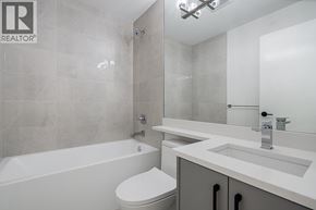 Burnaby apartment for rent - A white toilet sits next to a bathtub in a bathroom.