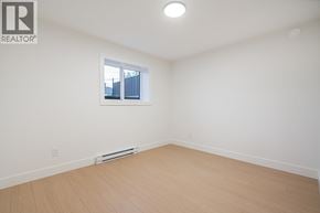 Burnaby apartment for rent - A white room with a window and a wooden floor.