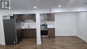 Haldimand apartment for rent - A kitchen with a refrigerator, sink, and cabinets.