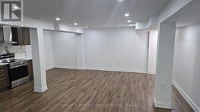 Haldimand apartment for rent - A spacious room with wooden flooring and white walls.